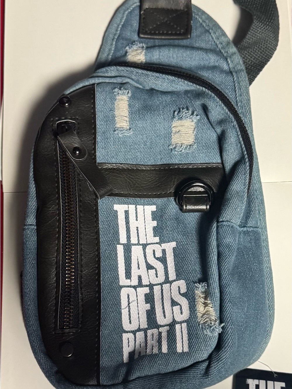 The last of us part 2 Blue Denim Sling Backpack with Bold White Logo